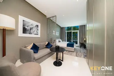 a living room with a couch and a bed at Elegant Studio Living in Privé in Dubai