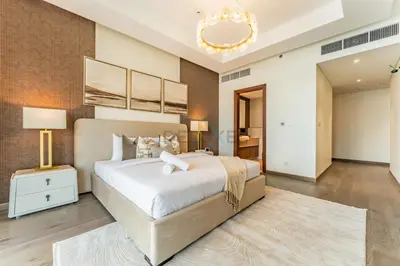 a large bedroom with a large bed and a chandelier at Elegant 3BR, Skyline Retreat in Downtown Dubai - Imperial Avenue, Downtown Dubai by Deluxe Holiday Homes in Dubai