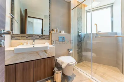 a bathroom with a sink and a shower at Elegant 3BR, Skyline Retreat in Downtown Dubai - Imperial Avenue, Downtown Dubai by Deluxe Holiday Homes in Dubai