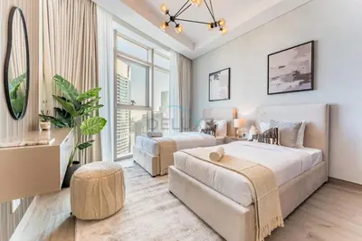 a bedroom with two beds and a couch at Elegant 3BR, Skyline Retreat in Downtown Dubai - Imperial Avenue, Downtown Dubai by Deluxe Holiday Homes in Dubai