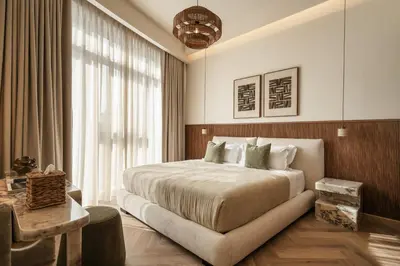 a bedroom with a large bed and a large window at Seraya Residences at Imperial Avenue Dubai in Dubai