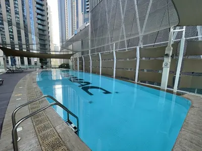 a large swimming pool in a building with tall buildings at Next to Dubai Mall & Burj Khalifa I Luxury Design in Dubai