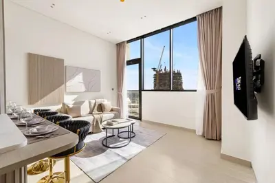 a living room with a couch and a table at Elevated 1BR with Private Pool at Binghatti Phantom in Dubai