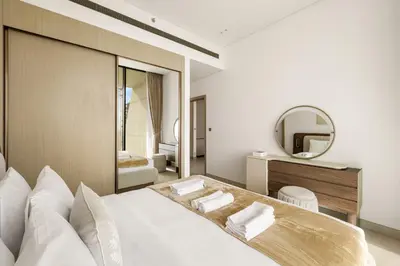 a bedroom with a large bed and a mirror at Elevated 1BR with Private Pool at Binghatti Phantom in Dubai