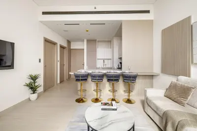 a living room with a couch and a table at Elevated 1BR with Private Pool at Binghatti Phantom in Dubai
