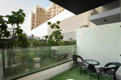 a balcony with chairs and a table and a fishtank at Escape24 Luxury Studio 100