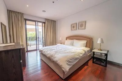 a bedroom with a large bed and a balcony at One bedroom appartment Palm Jumeirah in Dubai