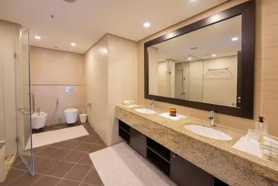 a bathroom with two sinks and a large mirror at One bedroom appartment Palm Jumeirah in Dubai