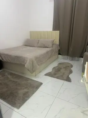 a bedroom with a bed and two rugs on the floor at Twin tower in Dubai