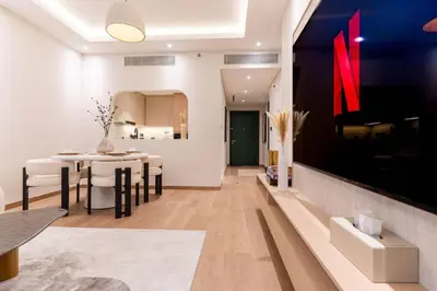 a living room with a table and a dining room at 1BR Plus Studio Apartment With Burj View In Downtown Dubai in Dubai