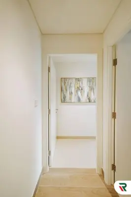 an empty room with a painting on the wall at 2BR Apartment With Lagoon Access In Creek Harbour in Dubai