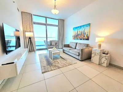 a living room with a couch and a table at Beachfront-Huge Apt-in Palm-Private Beach in Dubai
