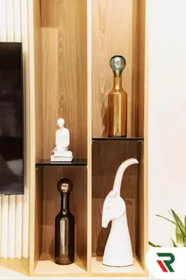 a wooden shelf with vases and bottles on it at 4 Bedroom Burj View Apartment In Downtown Dubai in Dubai