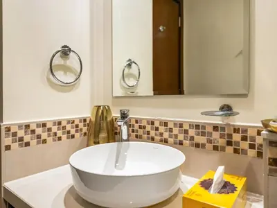 a bathroom with a white sink and a mirror at Chic 1BR With Burj Views And Near Dubai Mall in Dubai