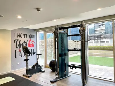 a fitness room with a gym with a treadmill at Chic 1BR With Burj Views And Near Dubai Mall in Dubai
