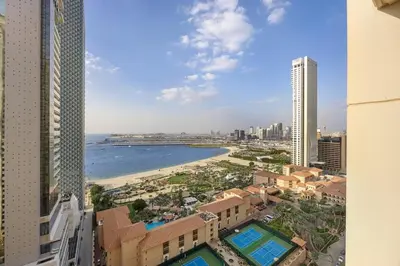 a view of a city with a beach and buildings at Beachfront JBR Stunning Views, Pool & Gym in Dubai