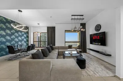 a living room with a couch and a table at Beachfront JBR Stunning Views, Pool & Gym in Dubai