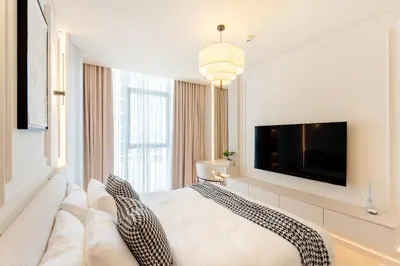 a living room with a couch and a flat screen tv at Urban Haven Pool, Gym & Spectacular Views in Dubai