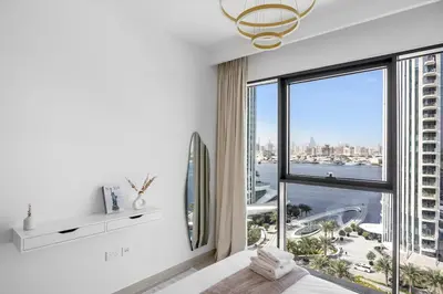 a bedroom with a large window with a view of the city at Burj Khalifa Views Luxury Stay with Pool & Gym in Dubai