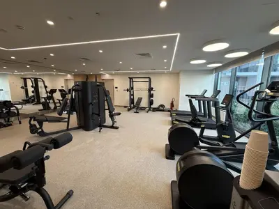 a gym with lots of treadmills and exercise bikes at Burj Khalifa Views Luxury Stay with Pool & Gym in Dubai