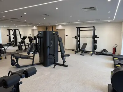 a gym with several tread machines in a room at Burj Khalifa Views Luxury Stay with Pool & Gym in Dubai