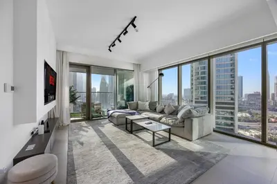 a living room with a couch and large windows at Burj Khalifa Views Pool, Gym & Downtown Ease in Dubai