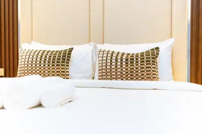 a close up of a bed with pillows at Modern 2BR Prime Downtown Location in Dubai