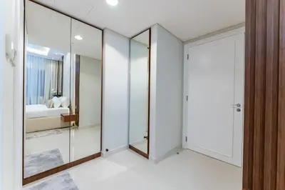 a bedroom with glass walls and a walk in closet at Modern 2BR Prime Downtown Location in Dubai