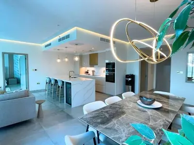 a kitchen and living room with a table and chairs at Luxury 2 Bedroom Shemara Tower Dubai Marina in Dubai