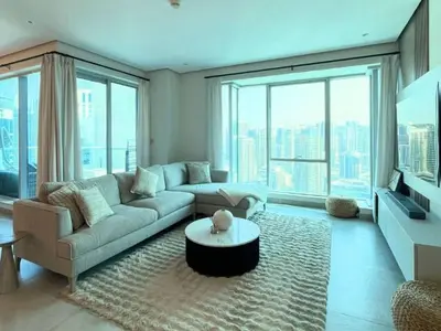 a living room with a couch and a table at Luxury 2 Bedroom Shemara Tower Dubai Marina in Dubai