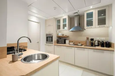 a kitchen with a sink and a counter top at FIRST CLASS 1BR Luxury Marina View Escape in Dubai