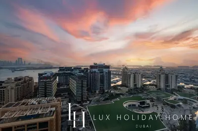 a view of a city with a sunset at LUX Iconic Views at The Palm Tower Suite 8 in Dubai