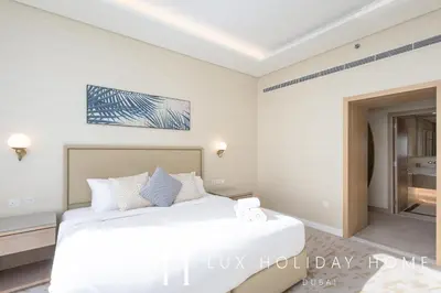 a bedroom with a white bed in a room at LUX Iconic Views at The Palm Tower Suite 8 in Dubai