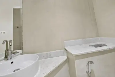a white bathroom with a sink and a tub at Stylish 1-Bedroom Apartment in Business Bay with Balcony Views in Dubai