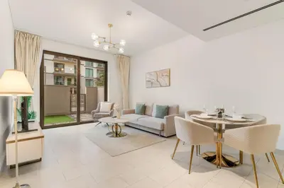 a living room with a table and a couch at FIRST CLASS 1BR Luxe Hideaway Escape in Dubai