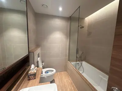 a bathroom with a toilet and a shower and a sink at have fun with your family and friends in our apt in Dubai