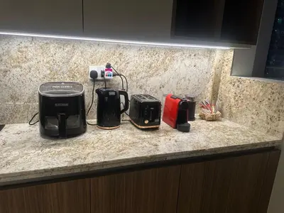 a kitchen counter with two toasters on a counter top at have fun with your family and friends in our apt in Dubai