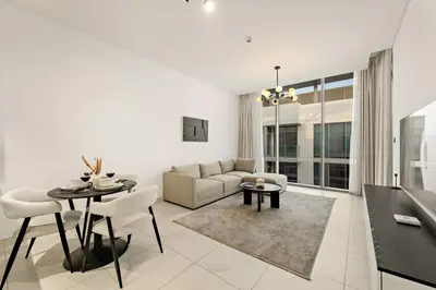 a living room with a couch and a table at FIRST CLASS 1BR Relaxing Urban Escape in Dubai