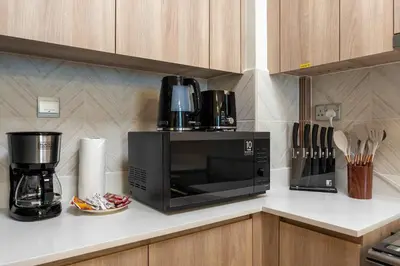 a microwave oven sitting on a counter in a kitchen at Luxury 2BR w City View Balcony in Dubai