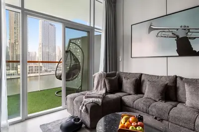 a living room with a couch and a large window at Gogoto6 2BR Super Premium Canal & Burj Khalifa View in Dubai