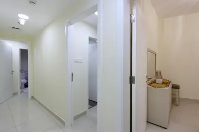 a hallway with a glass door leading to a bathroom at Prime Located 3B with full Marina Views, Near Beach & Marina Mall in Dubai