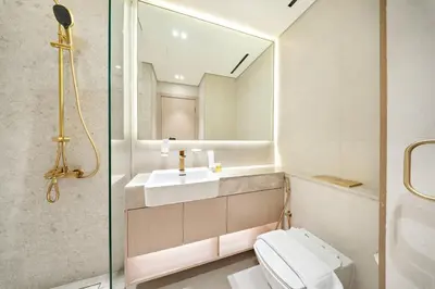a bathroom with a toilet and a sink and a mirror at FIRST CLASS Studio Stylish Near Circle Mall in Dubai