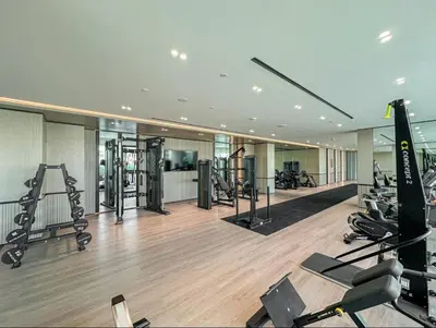 a gym with treadmills and machines in a building at FIRST CLASS Studio Stylish Near Circle Mall in Dubai