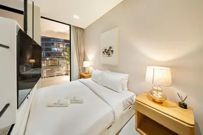 a bedroom with a white bed and a large window at FIRST CLASS Studio Stylish Near Circle Mall in Dubai