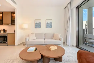 a living room with a couch and a table at Luxury 1BR Beach Access Creek Beach in Dubai