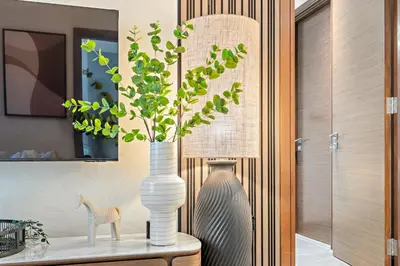 a vase with a plant in it on a table at FIRST CLASS 2BR Classy Getaway Near Downtown in Dubai