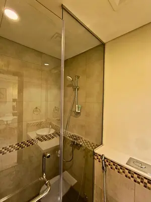 a bathroom with a shower and a sink at Canal View - 10 Minutes Walk to Dubai Mall in Dubai