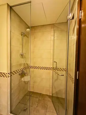 a shower with a glass door in a bathroom at Canal View - 10 Minutes Walk to Dubai Mall in Dubai