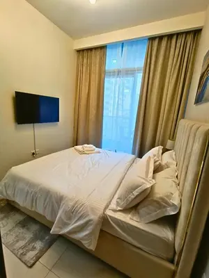 a bedroom with a bed with a large window at Canal View - 10 Minutes Walk to Dubai Mall in Dubai