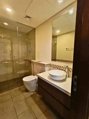 a bathroom with a toilet and a sink and a shower at Canal View - 10 Minutes Walk to Dubai Mall in Dubai